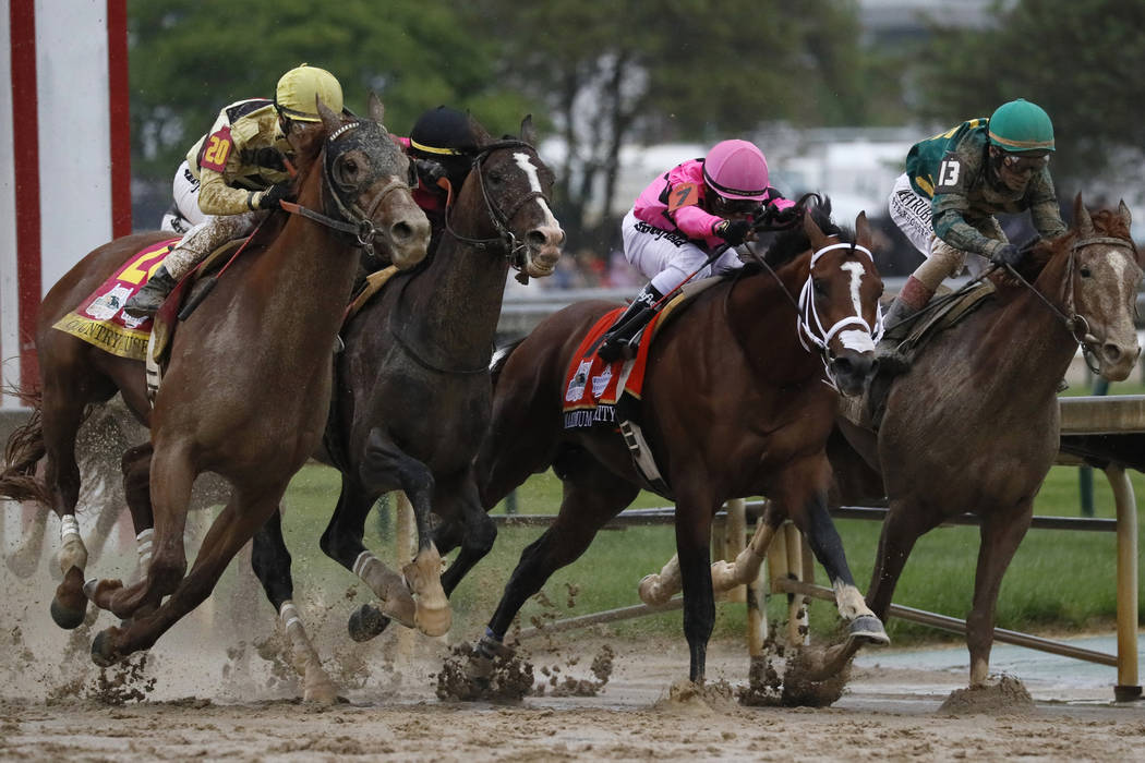 In this May 4, 2019, file photo, Flavien Prat on Country House, left, races against Luis Saez o ...