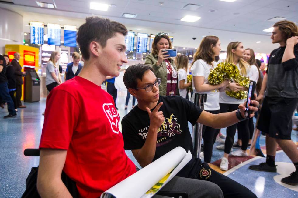 Faith Lutheran senior Mark Wilbourne, left, takes a selfie with Steve Mascella during a welcome ...