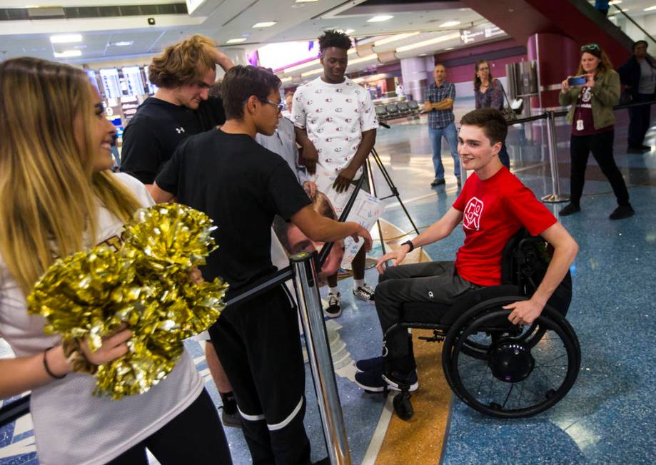 Faith Lutheran senior Mark Wilbourne, in red, greets friends at McCarran International Airport ...