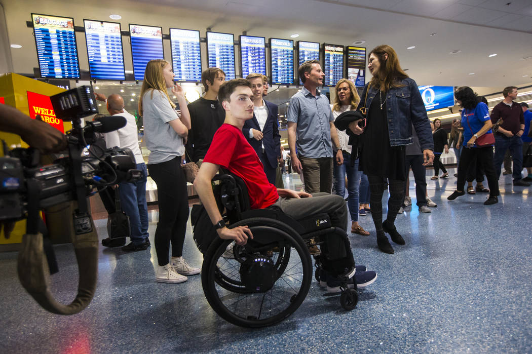 Faith Lutheran senior Mark Wilbourne, in red, reacts to a welcome party at McCarran Internation ...