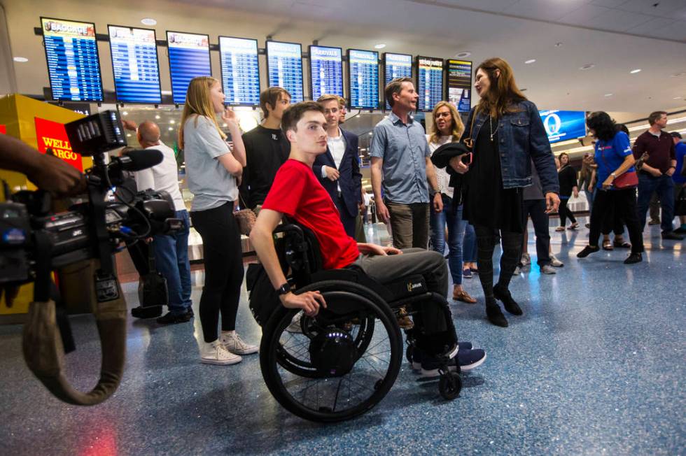 Faith Lutheran senior Mark Wilbourne, in red, reacts to a welcome party at McCarran Internation ...