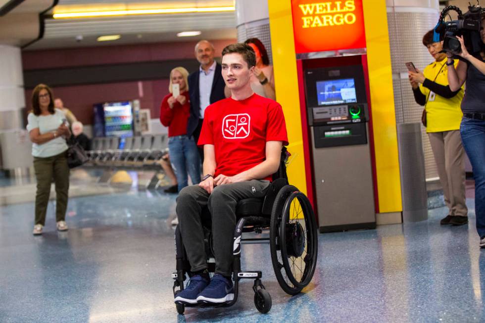 Faith Lutheran senior Mark Wilbourne reacts to a welcome party at McCarran International Airpor ...