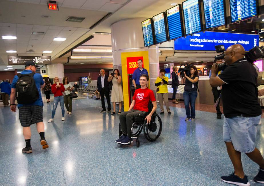 Faith Lutheran senior Mark Wilbourne, in red, reacts to a welcome party at McCarran Internation ...