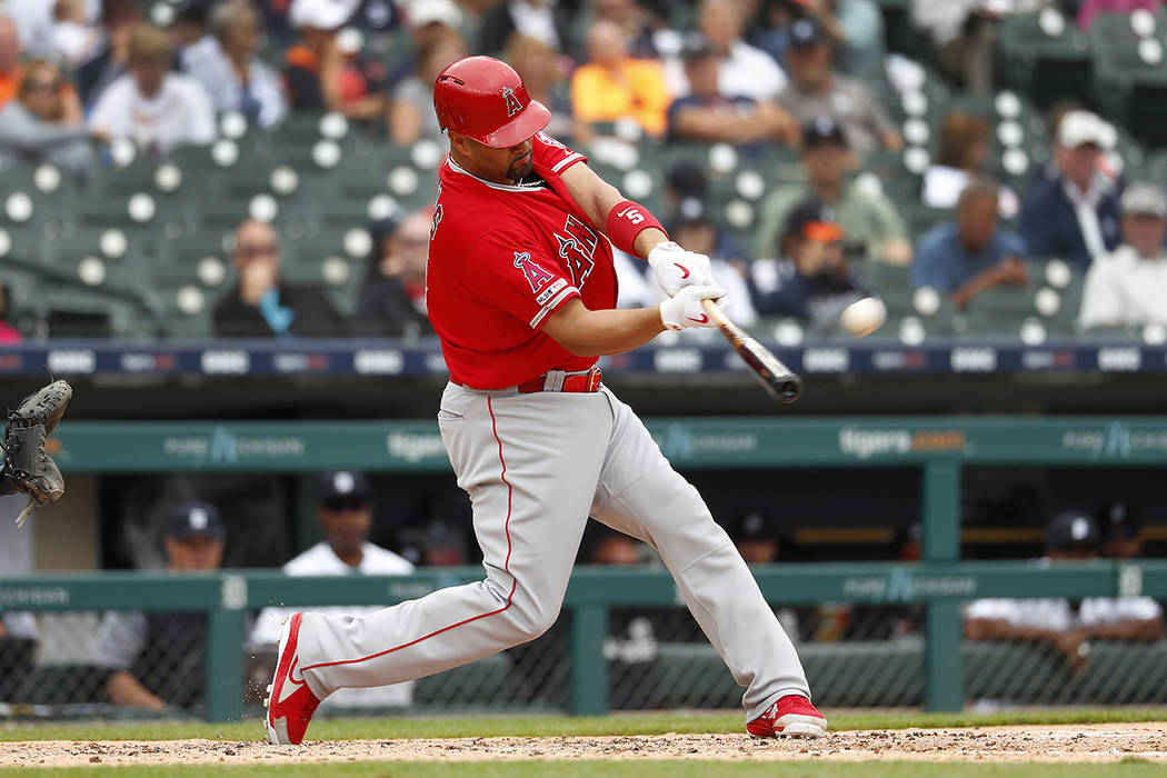 Los Angeles Angels' Albert Pujols hits a solo home run in the third inning of a baseball game a ...