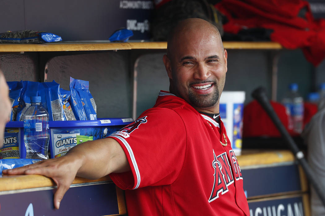 Los Angeles Angels' Albert Pujols smiles in the dugout after hitting a solo home run in the thi ...