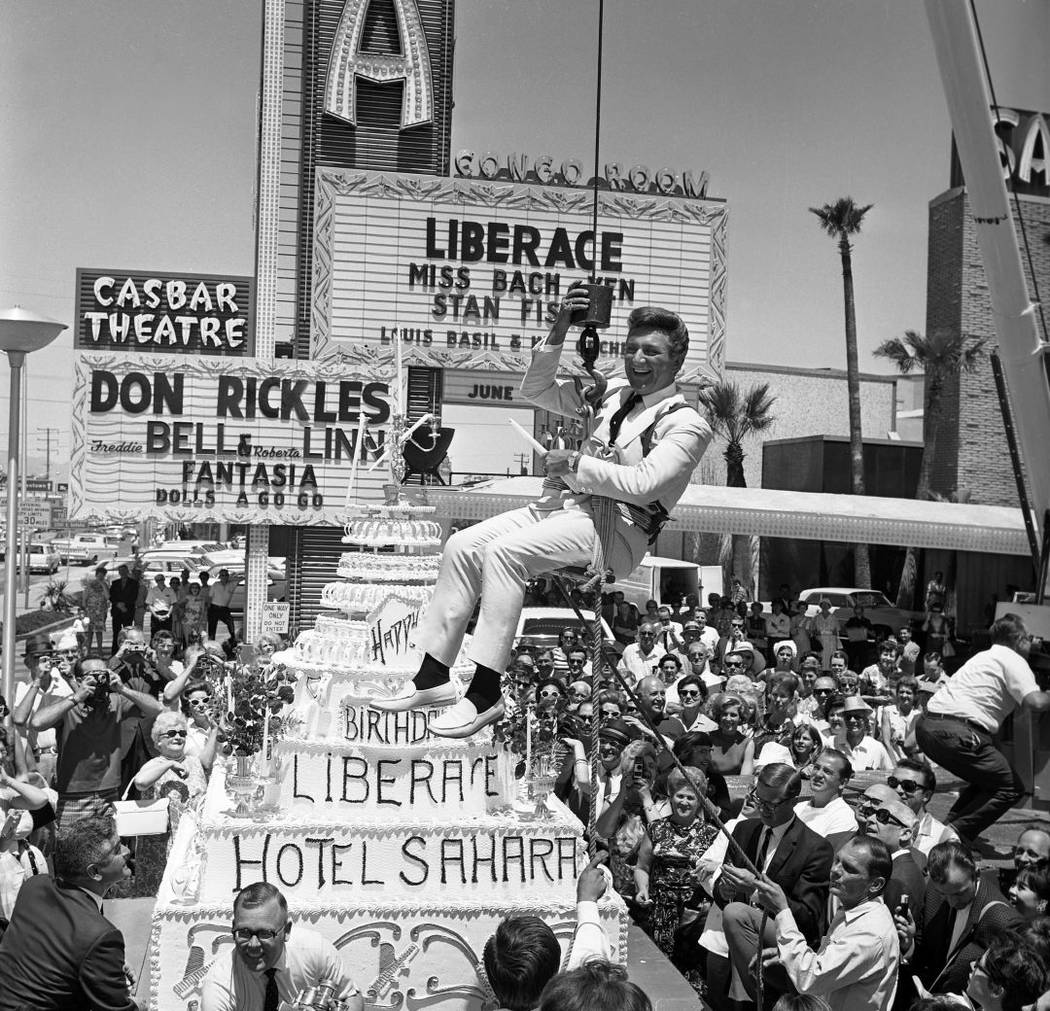 Liberace being presented with a large cake in front of the Sahara Hotel on May 16, 1967. (Las V ...