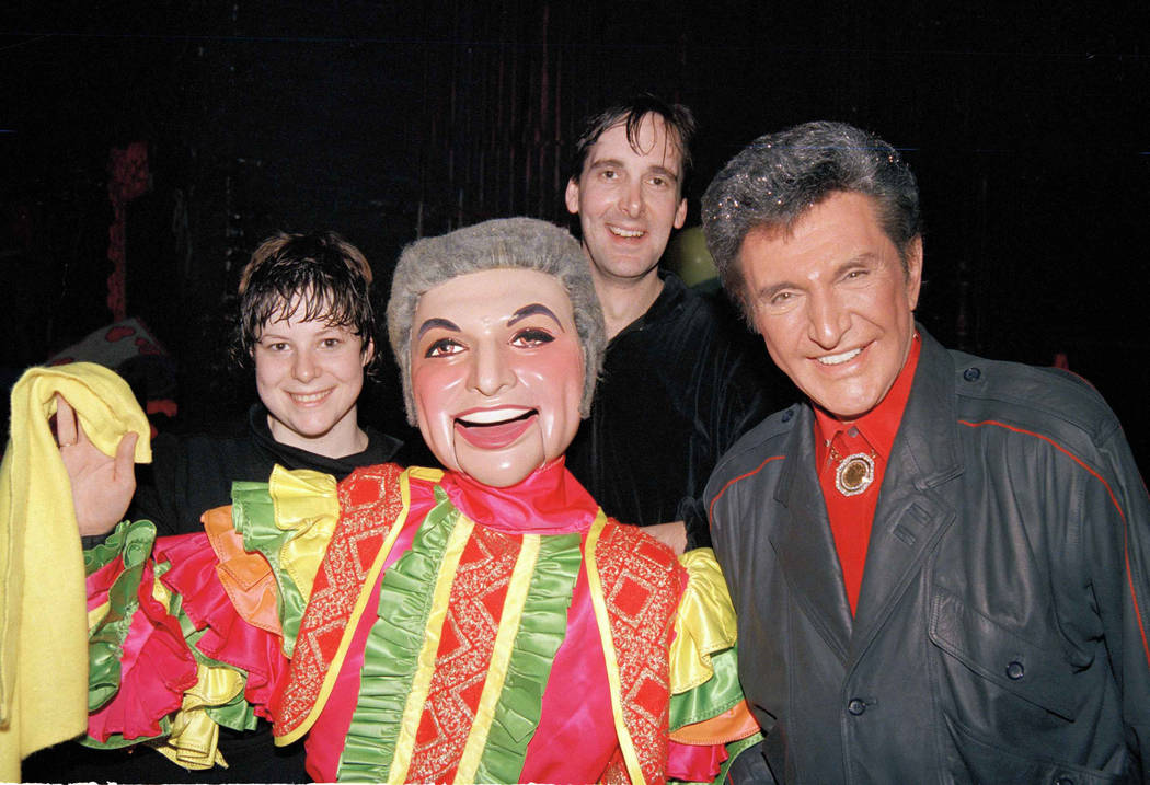 Entertainer Liberace, right, poses with a puppet, fashioned after the star, center, backstage S ...
