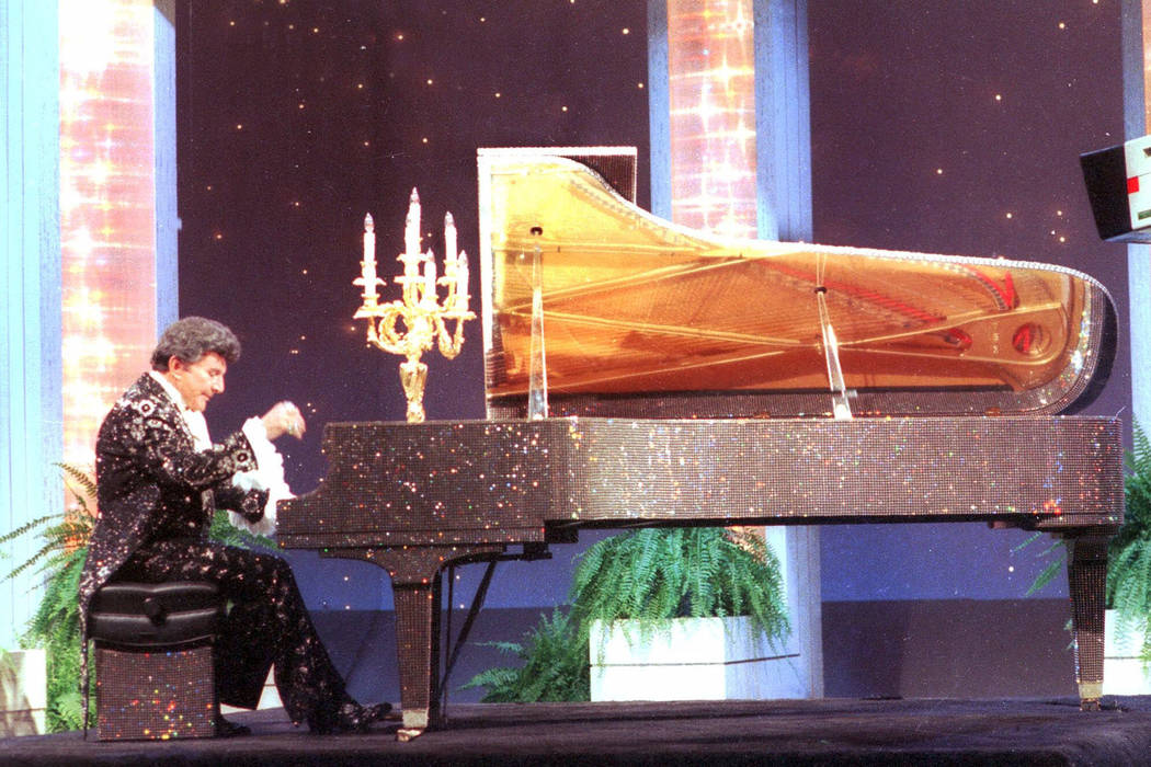 Liberace plays the piano on the Johnny Carson Show night of Sept. 5, 1984. (AP Photo)