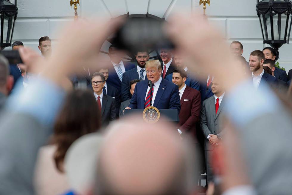 President Donald Trump, center, speaks during a ceremony on the South Lawn of the White House i ...