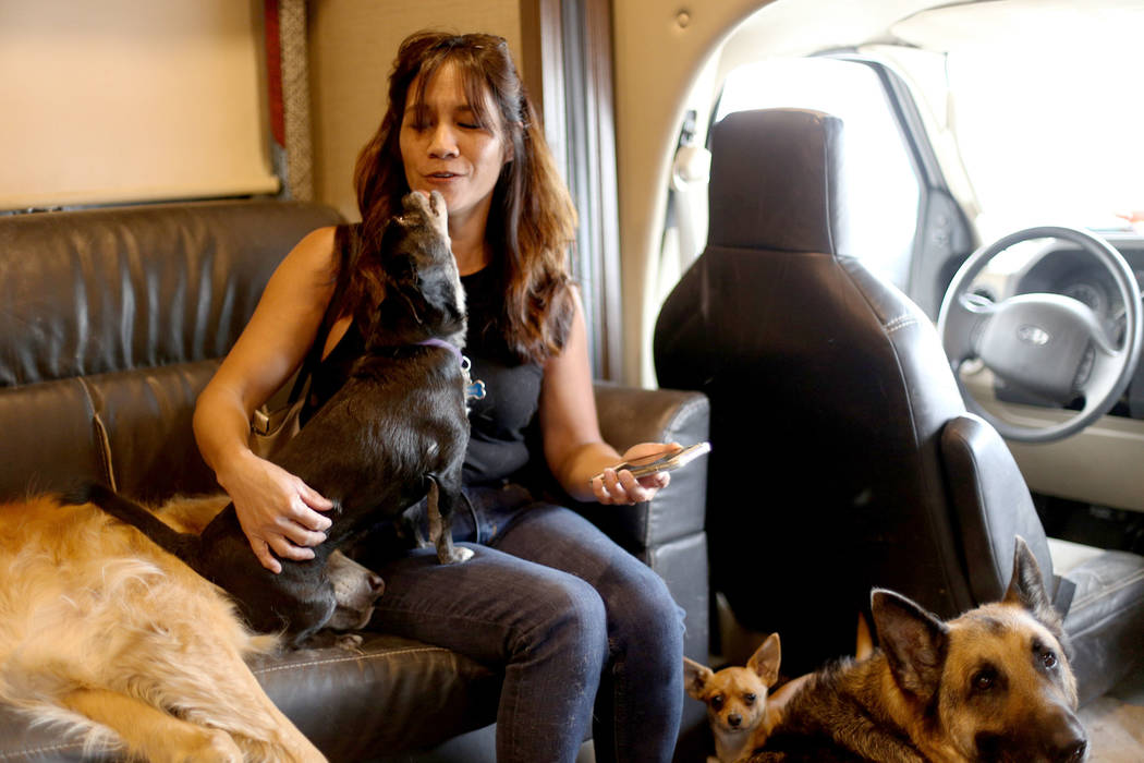 Michelle Silva, of Henderson, receives kisses from Molly in The Asher House RV in the parking l ...