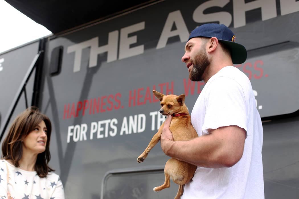 Lee Asher talks to fans while holding Penny outside The Asher House RV in the parking lot of Ne ...