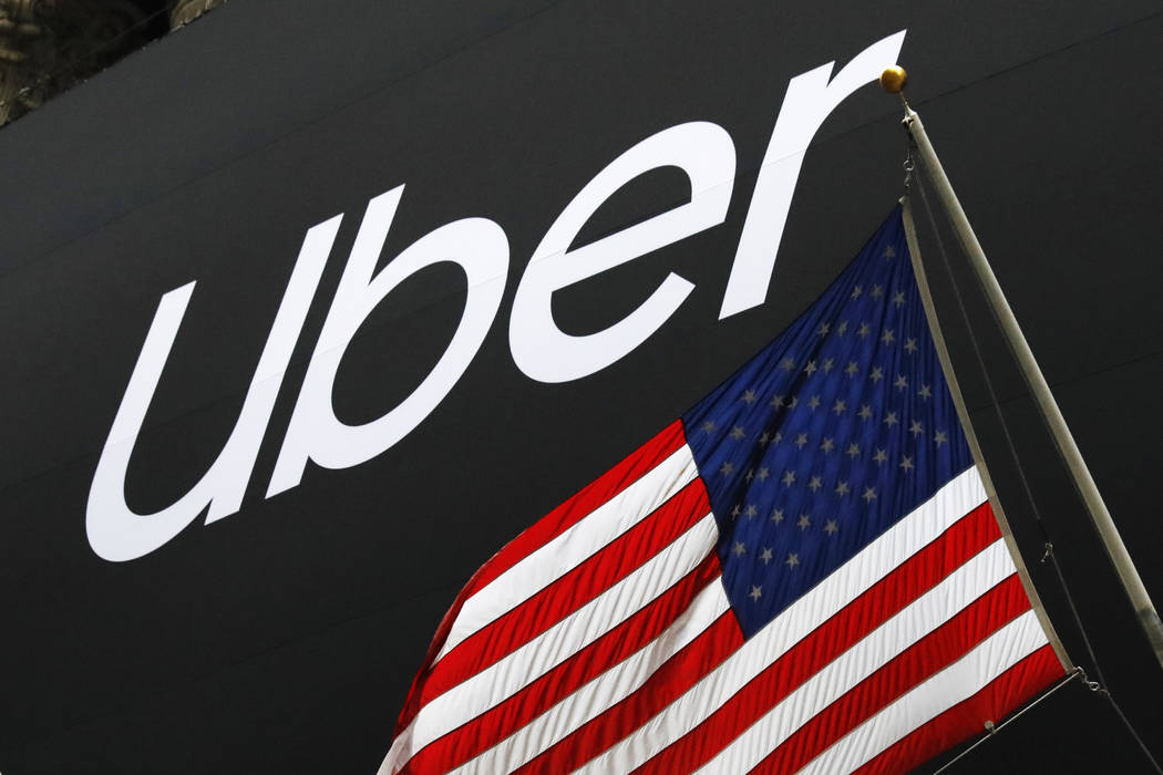 A banner for Uber is draped on the front of the New York Stock Exchange before the world's larg ...