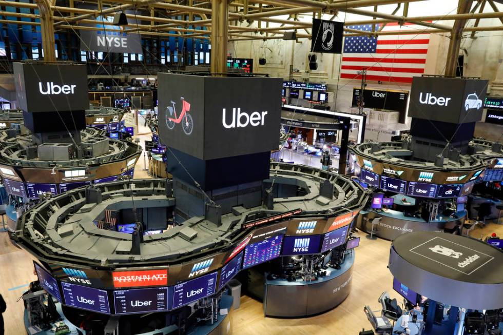 Uber logos top trading posts on the floor of the New York Stock Exchange, Friday, May 10, 2019. ...