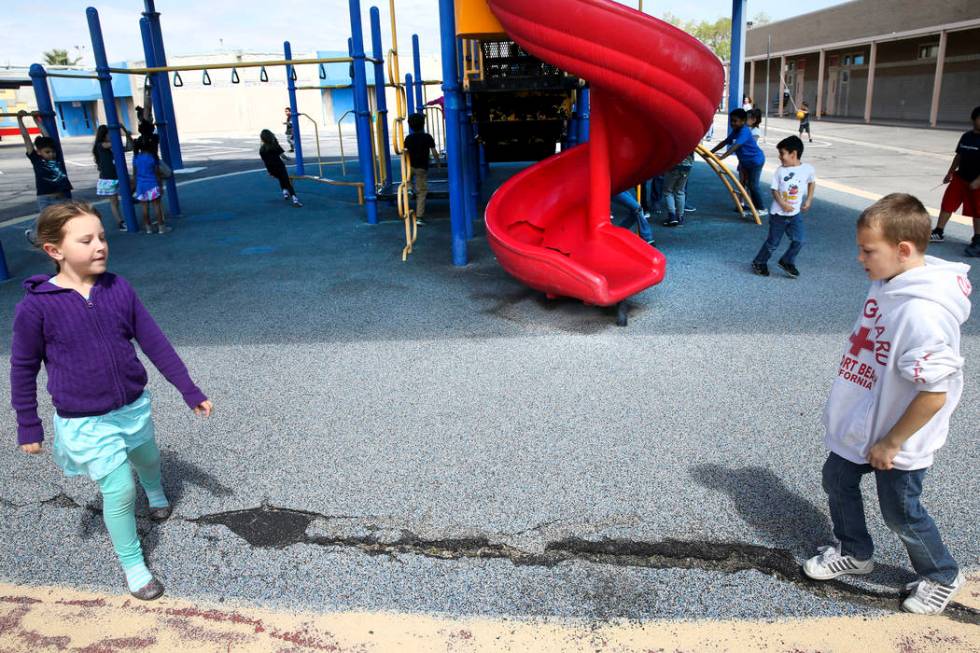 Klarie Fancher and Mason Thomas show damage on their playground at Helen Smith Elementary Schoo ...