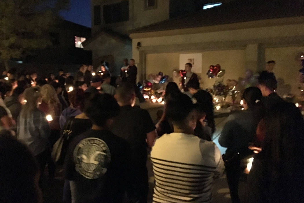 Mourners gather to remember Angelina Erives during a vigil Saturday, Nov. 3, 2018, on Courtney ...