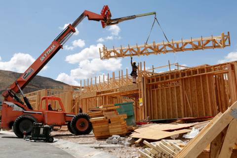 Workers construct houses near the corner of Mesa Park Drive and Hualapai Way in Summerlin, Frid ...