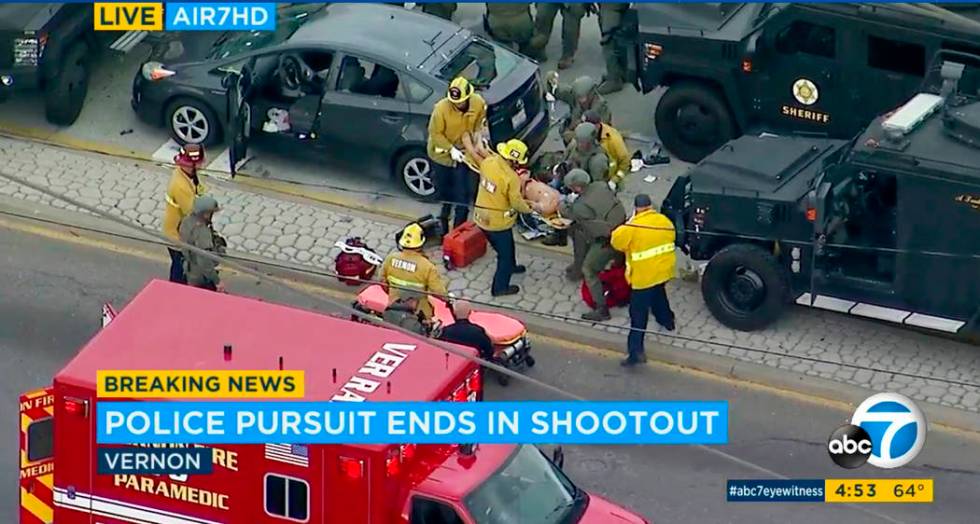 In this photo taken from video provided by KABC-TV, medics and officers tend to a wounded man a ...
