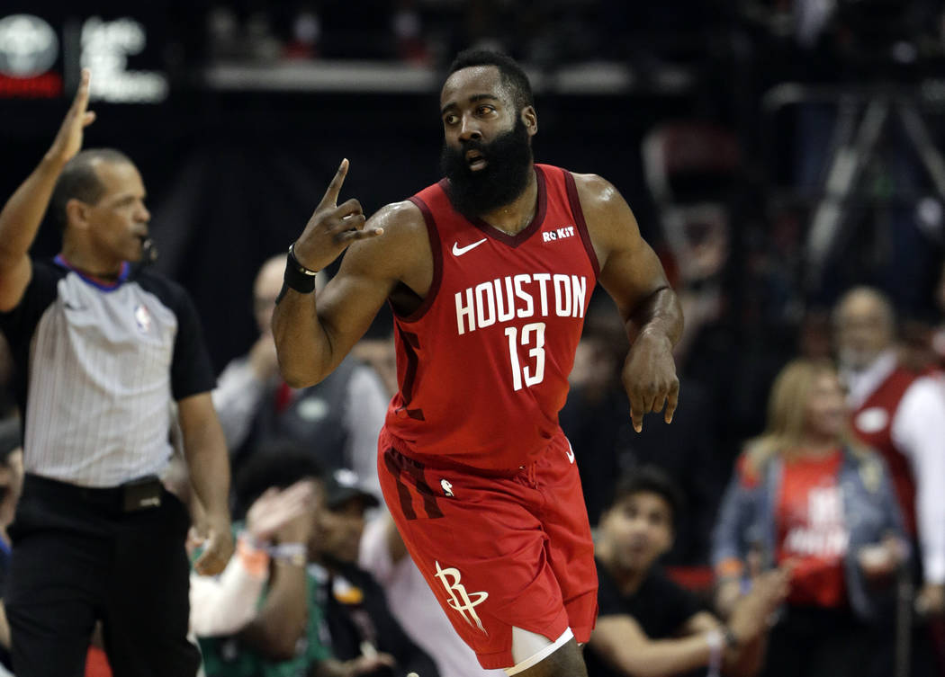 Houston Rockets' James Harden (13) celebrates a basket against the Golden State Warriors during ...