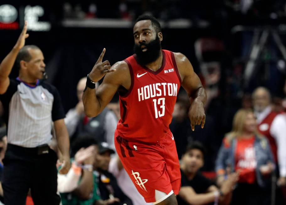 Houston Rockets' James Harden (13) celebrates a basket against the Golden State Warriors during ...