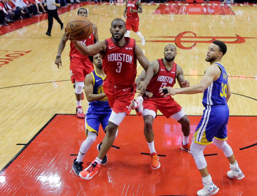 Houston Rockets guard Chris Paul (3) drives past Golden State Warriors guard Stephen Curry (30) ...