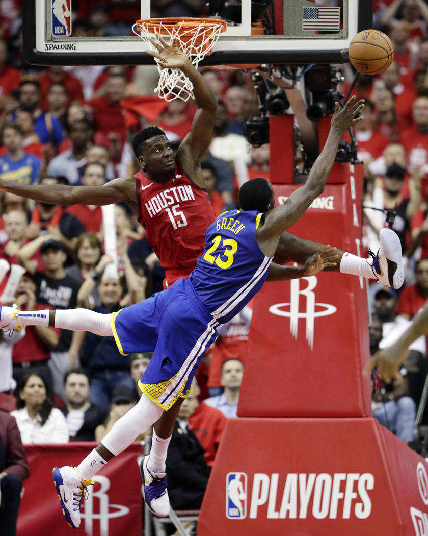 Golden State Warriors forward Draymond Green (23) shoots asHouston Rockets center Clint Capela ...