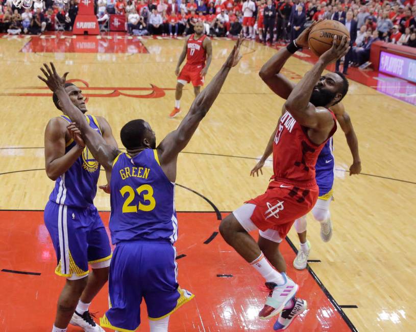 Houston Rockets guard James Harden (13) shoots over Golden State Warriors forward Draymond Gree ...