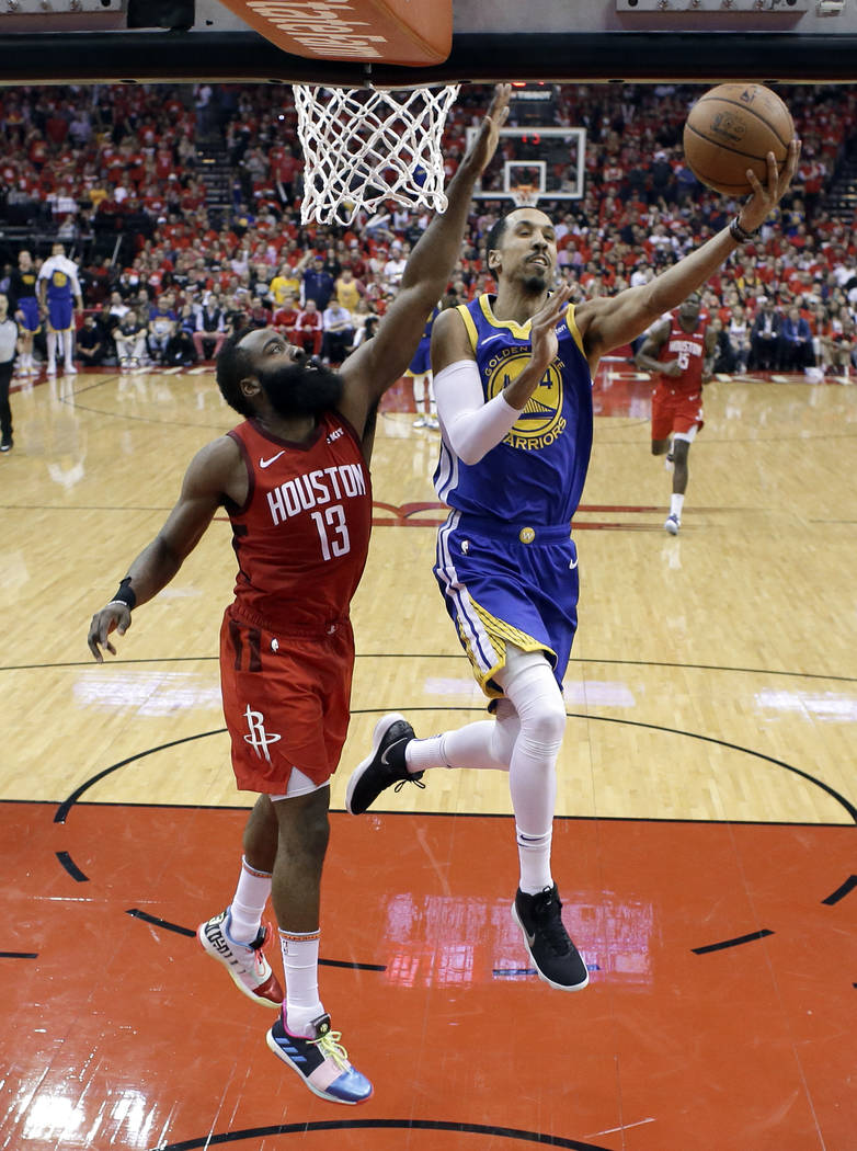 Houston Rockets' James Harden (13) defends as Golden State Warriors' Shaun Livingston goes up f ...