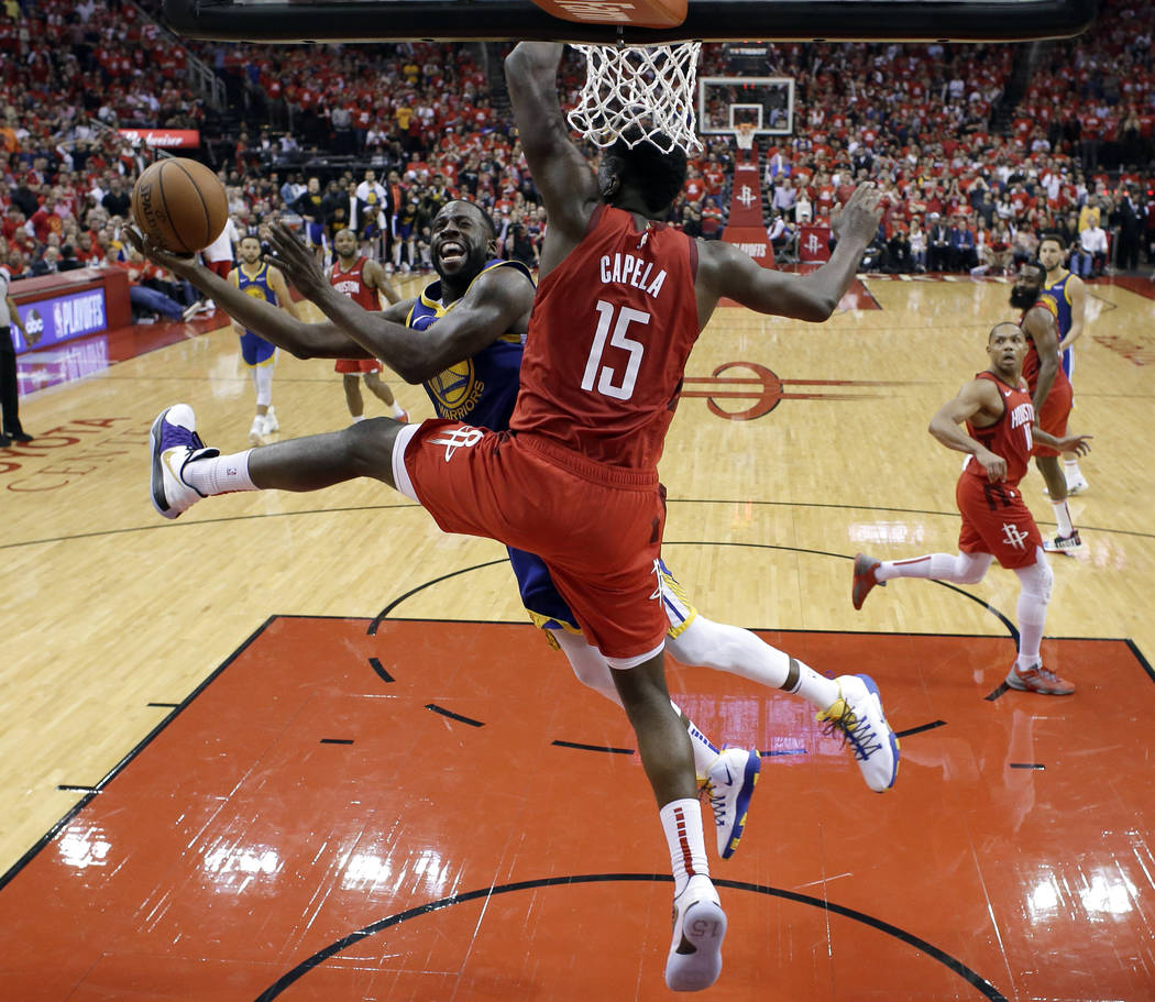 Golden State Warriors' Draymond Green (23) goes up for a shot as Houston Rockets' Clint Capela ...