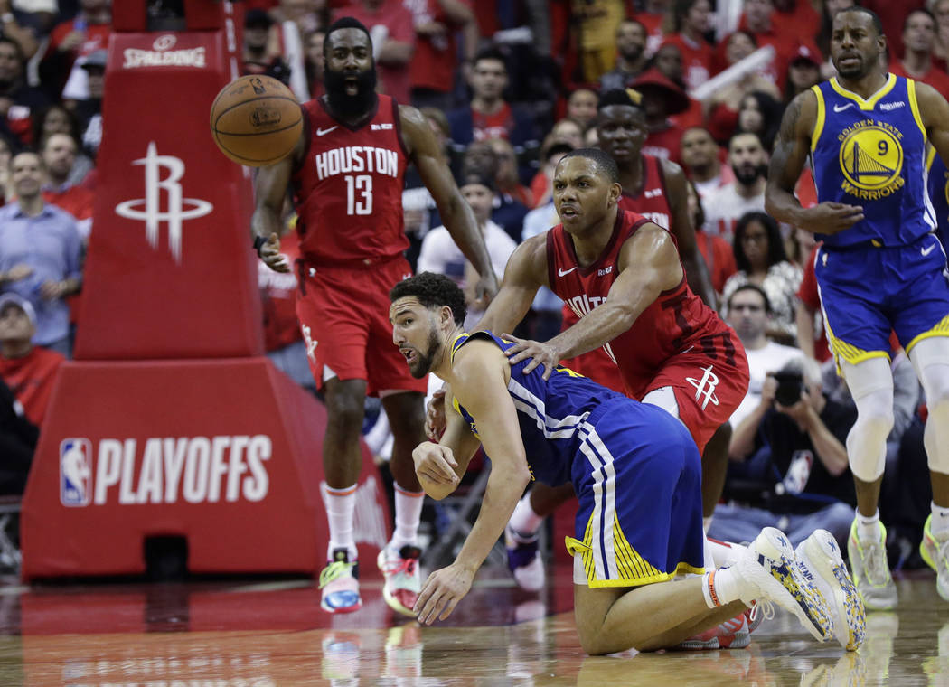 Golden State Warriors guard Klay Thompson, front left, flips the ball away from Houston Rockets ...