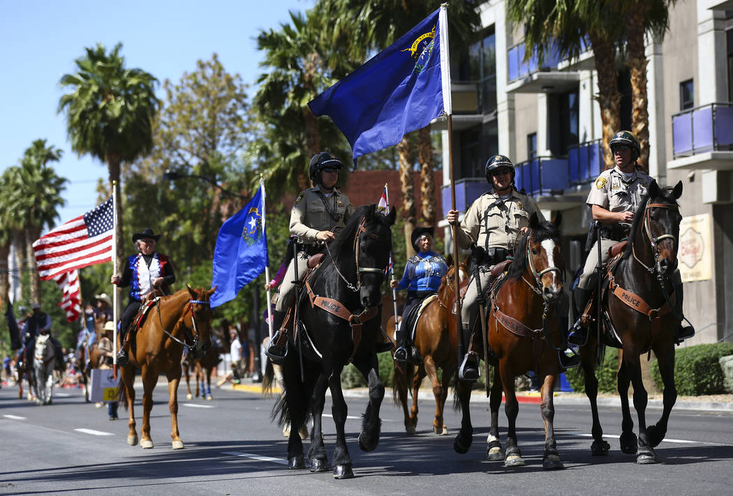 Las Vegas police officers participate in the Helldorado Parade along Fourth Street in downtown ...