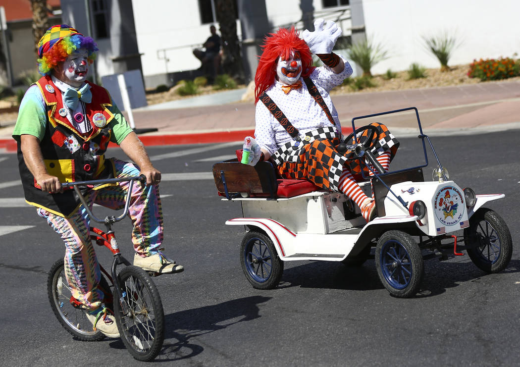 Members of the Zelzah Shrine Clowns participate in the Helldorado Parade along Fourth Street in ...