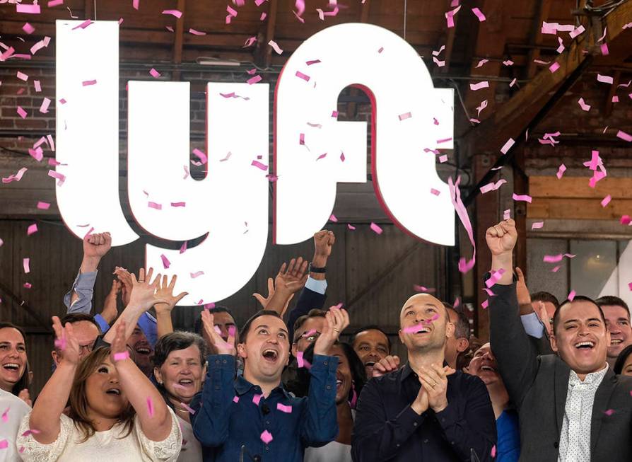 In this Friday, March 29, 2019 file photo, Lyft co-founders John Zimmer, front second from left ...
