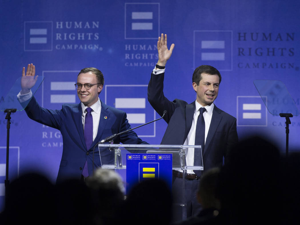 Democratic presidential candidate Pete Buttigieg, right, and husband Chasten Glezman wave to th ...