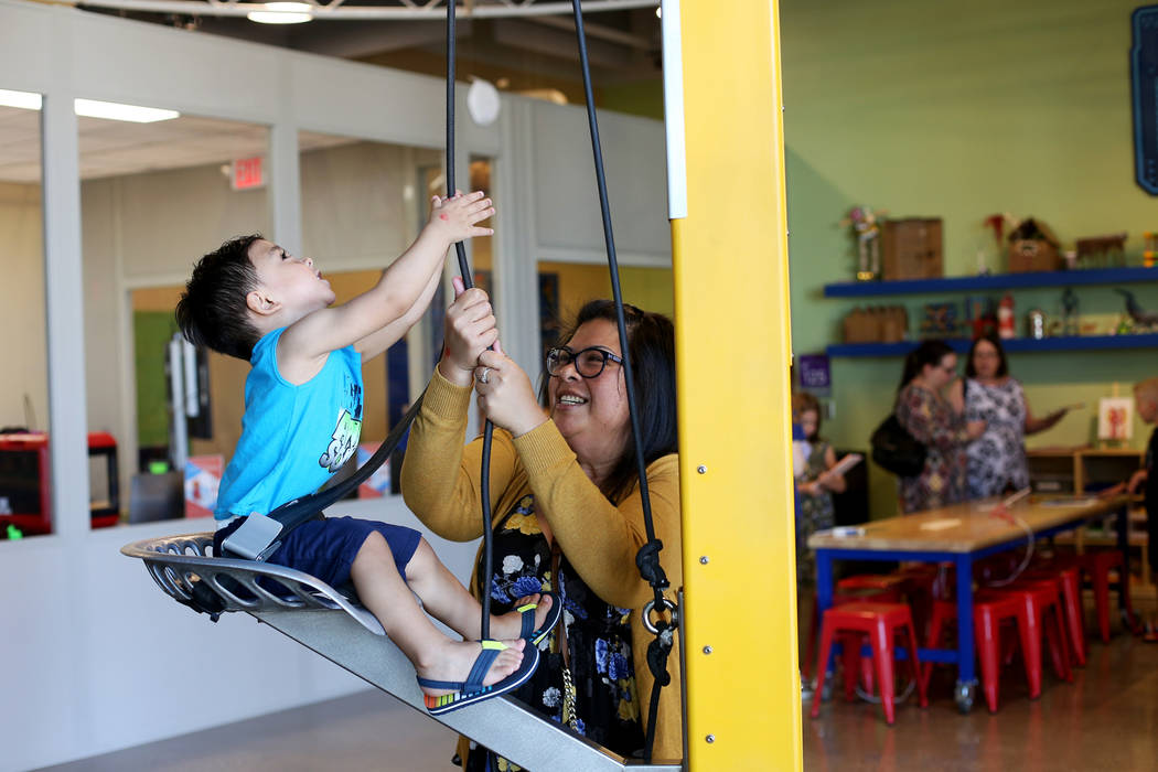 Maricel Thweatt plays with her son Liam Thweatt, 2, at the Mother's Day Morning of Cookies &amp ...