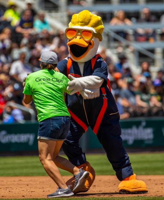 Puddles the Duck attempts to slow down Erica Haskin as they race around the bases while the Avi ...