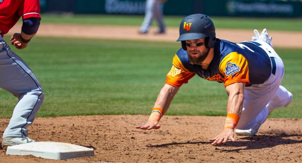 The Aviators Nick Martini (38) dives back to first base during a game versus the Tacoma Rainier ...