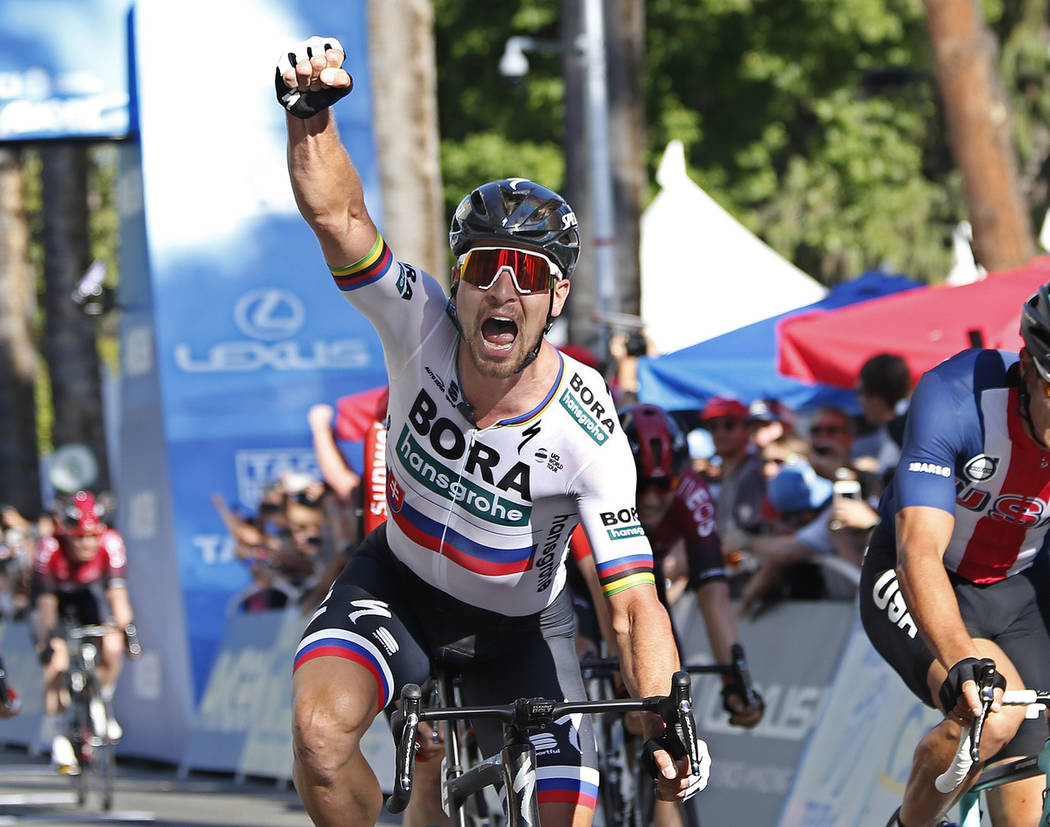 Peter Sagan, of the Bora-hansgrohe team, celebrates after crossing the finish line to win the f ...