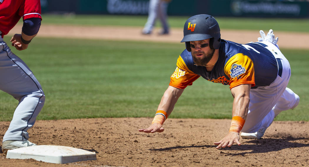 The Aviators Nick Martini (38) dives back to first base during a game versus the Tacoma Rainier ...