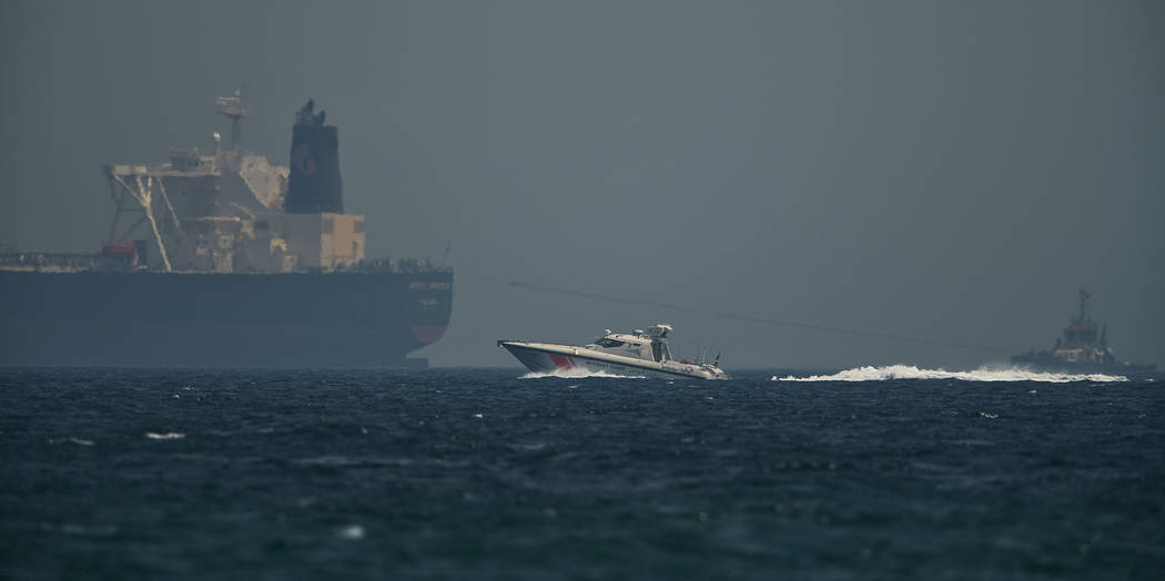 An Emirati coast guard vessel passes an oil tanker off the coast of Fujairah, United Arab Emira ...