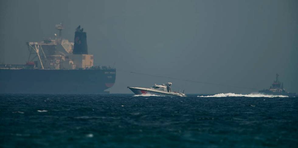 An Emirati coast guard vessel passes an oil tanker off the coast of Fujairah, United Arab Emira ...