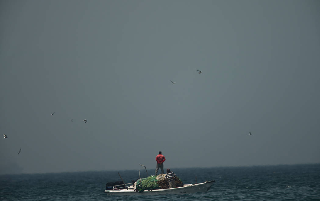 A fishing boat sails in waters off the coast of Fujairah, United Arab Emirates, Monday, May 13, ...