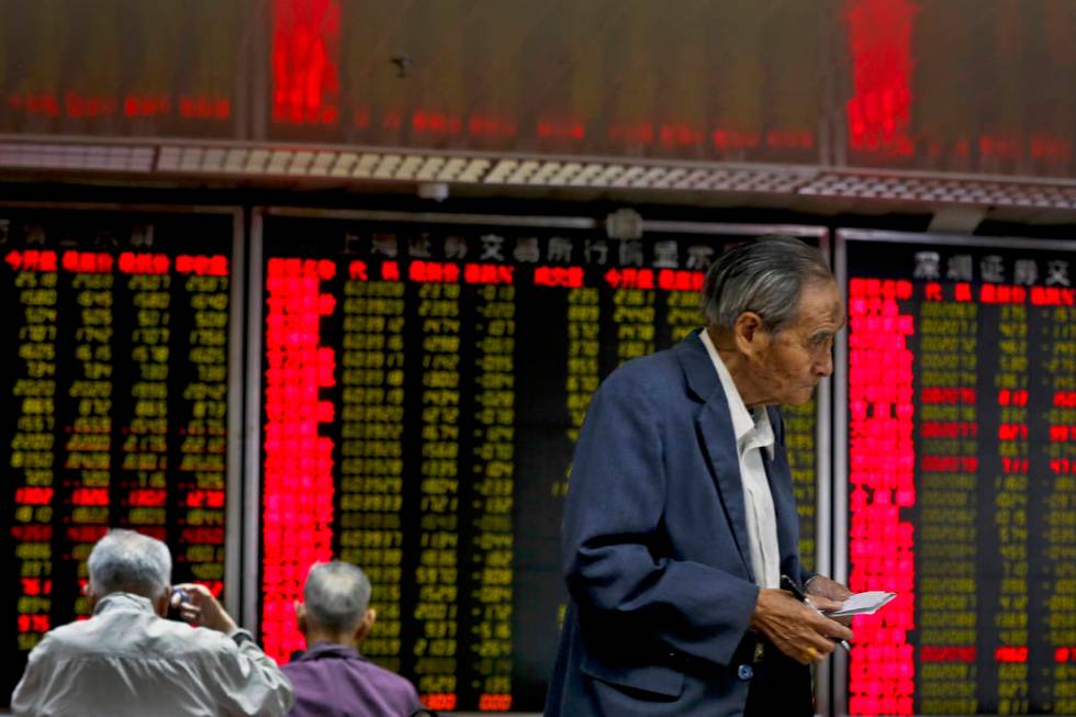 Chinese investors monitor stock prices at a brokerage house in Beijing, Monday, May 13, 2019. S ...