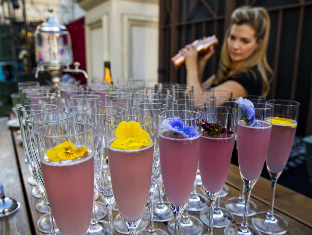 Mixologist Barrie Webster works to create a High Pollen Countess cocktail during a Vegas Uncork ...