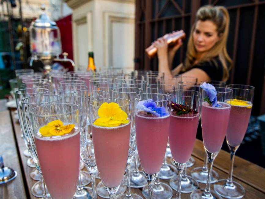 Mixologist Barrie Webster works to create a High Pollen Countess cocktail during a Vegas Uncork ...
