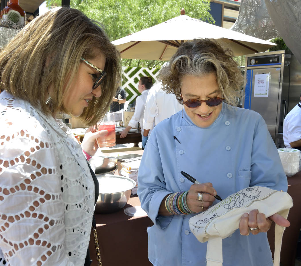 Chef Susan Feniger of Border Grill, right, autographs a bag for Adelina Badalyan during Picnic ...