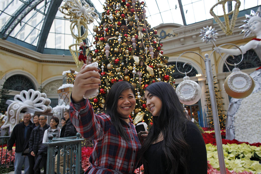 Shu Pan, left, and Michelle Leon take a selfie at the Bellagio Conservatory & Botanical Gar ...
