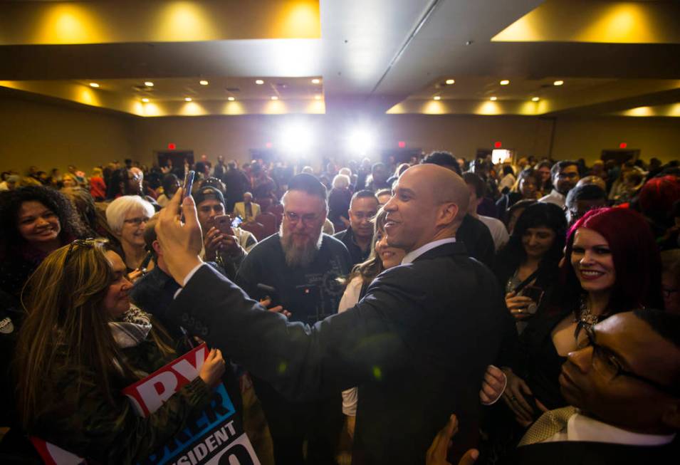 U.S. Sen. Cory Booker, D-N.J., a Democratic presidential hopeful, takes a selfie while greeting ...