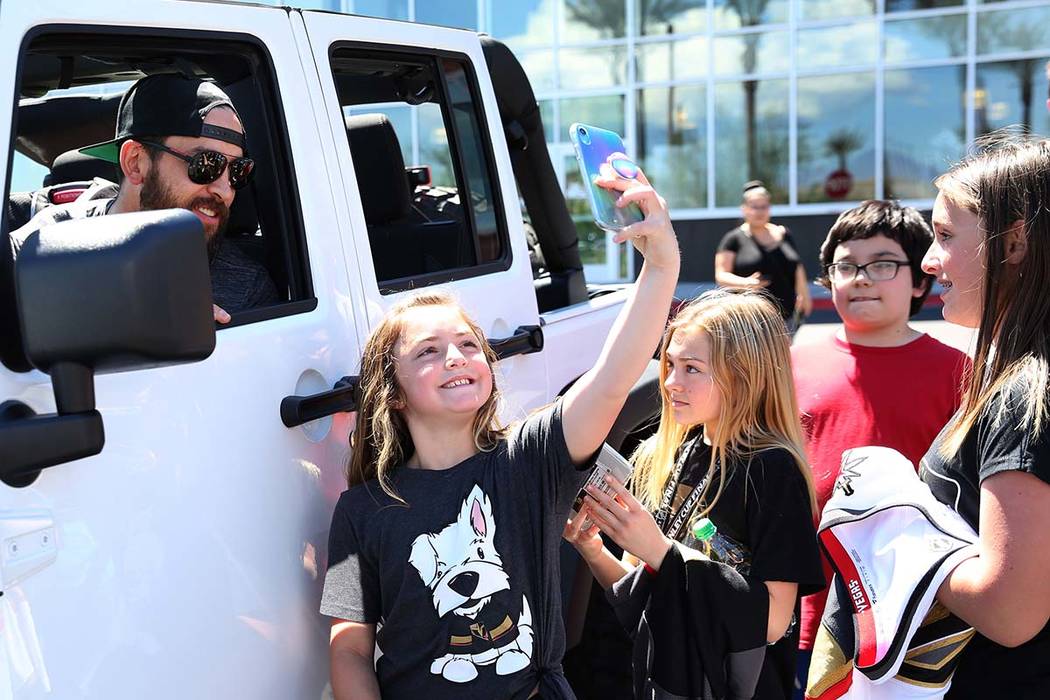Golden Knights defenseman Deryk Engelland poses for a selfie with fans outside City National Ar ...