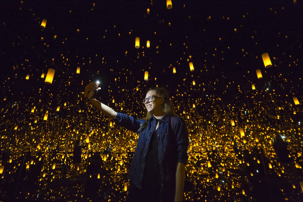 Kate Rosen, 25, of California snaps a selfie inside Yayoi Kusama's Infinity Mirrored Room at th ...