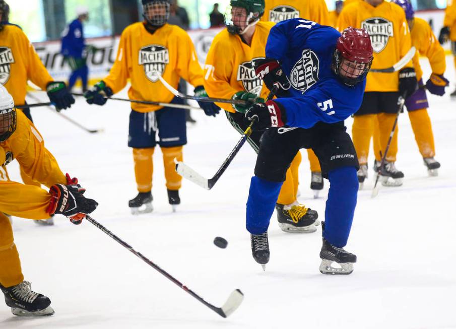 Team Blue's Matthew Gross (51) shoots against Team Yellow during a game in the USA Hockey Pacif ...